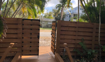 Shadow box painted fence and wood deck