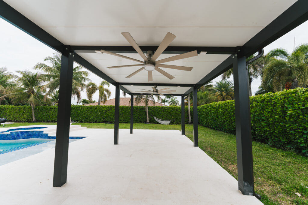 Modern aluminum pergola with ceiling fan over a pool deck