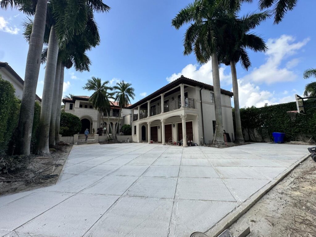 Concrete driveway slabs with turf joints in front of a South Florida home by Canet Group