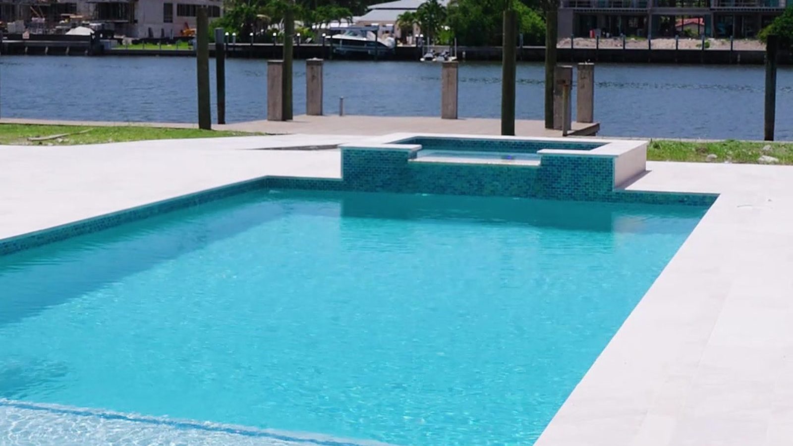 New waterfront pool with a raised spa built by Canet Group in South Florida