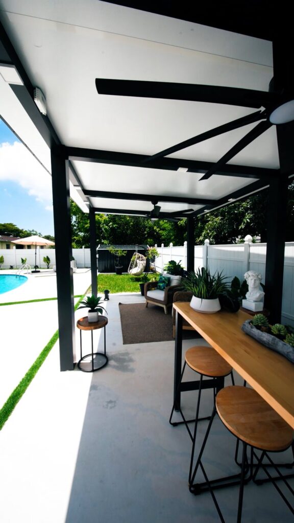 Aluminum pergola over a lounge seating area built by Canet Group