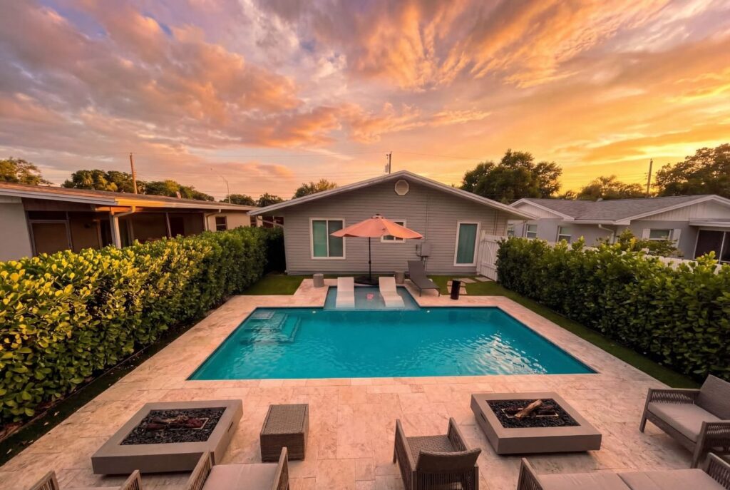 Renovated pool with travertine patio at sunset