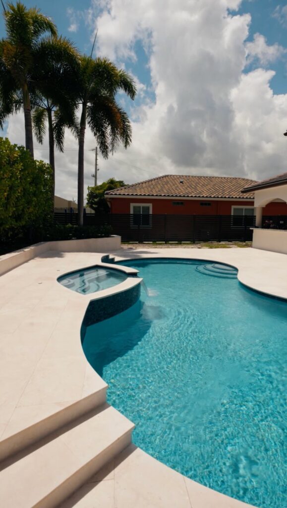 Renovated pool and spa behind a South Florida home by Canet Group
