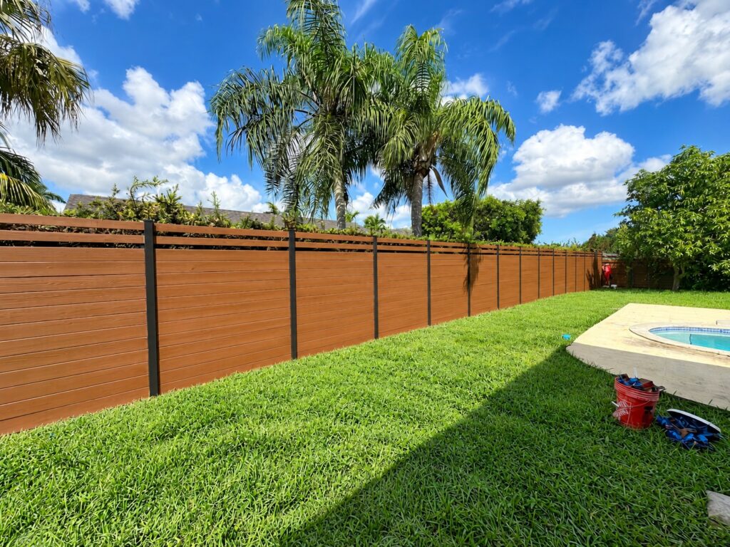 Horizontal wood fence around a pool backyard in South Florida