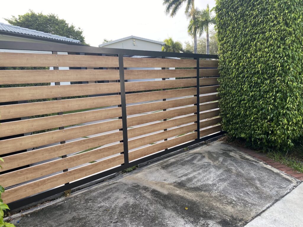 Horizontal wood-look slat gate on a modern home exterior