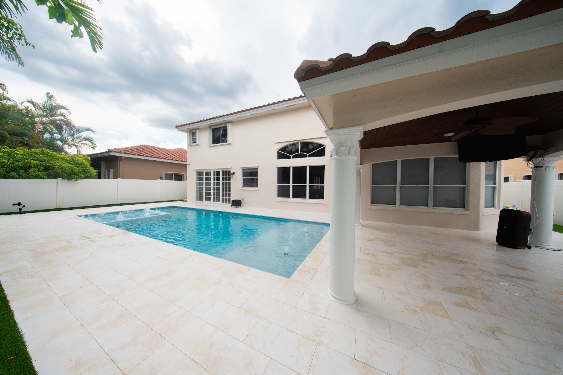 Renovated pool with a new deck beside a covered patio, refreshed by Canet Group