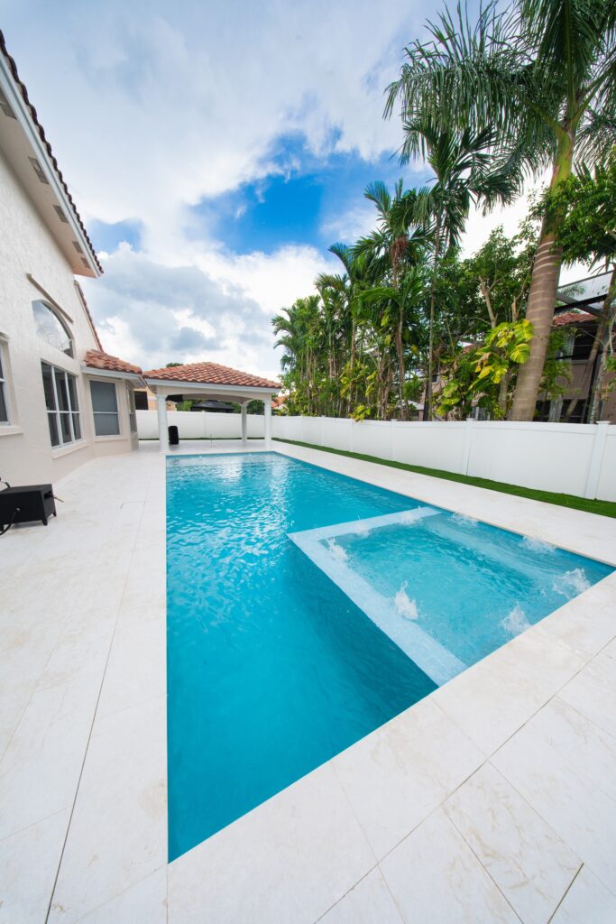Resurfaced pool and spa with a new porcelain deck after a Canet Group pool renovation