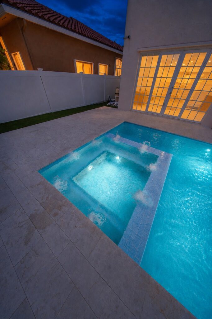 Renovated spa with new waterline tile and lighting at night